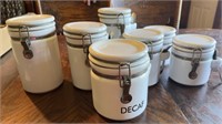 7 White kitchen canisters with spoon holders and