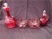 Four pieces of cranberry glass: two cruets,