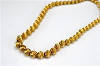 Graduated gold ball bead necklace