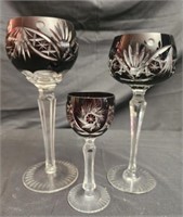 3 dark cranberry colored crystal glasses