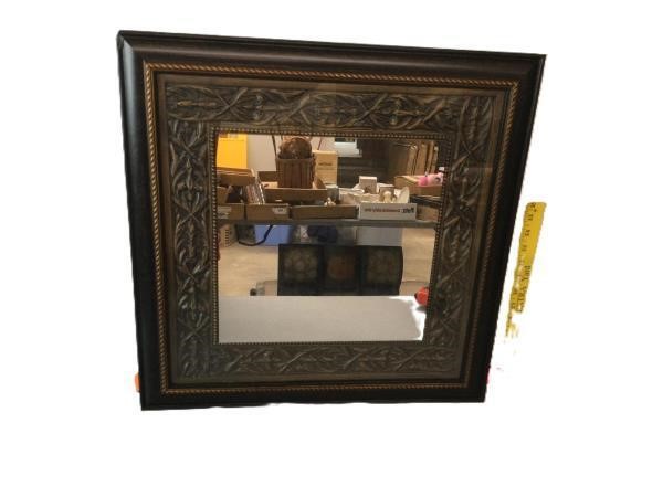 Ornate brown picture frame with beveled mirror