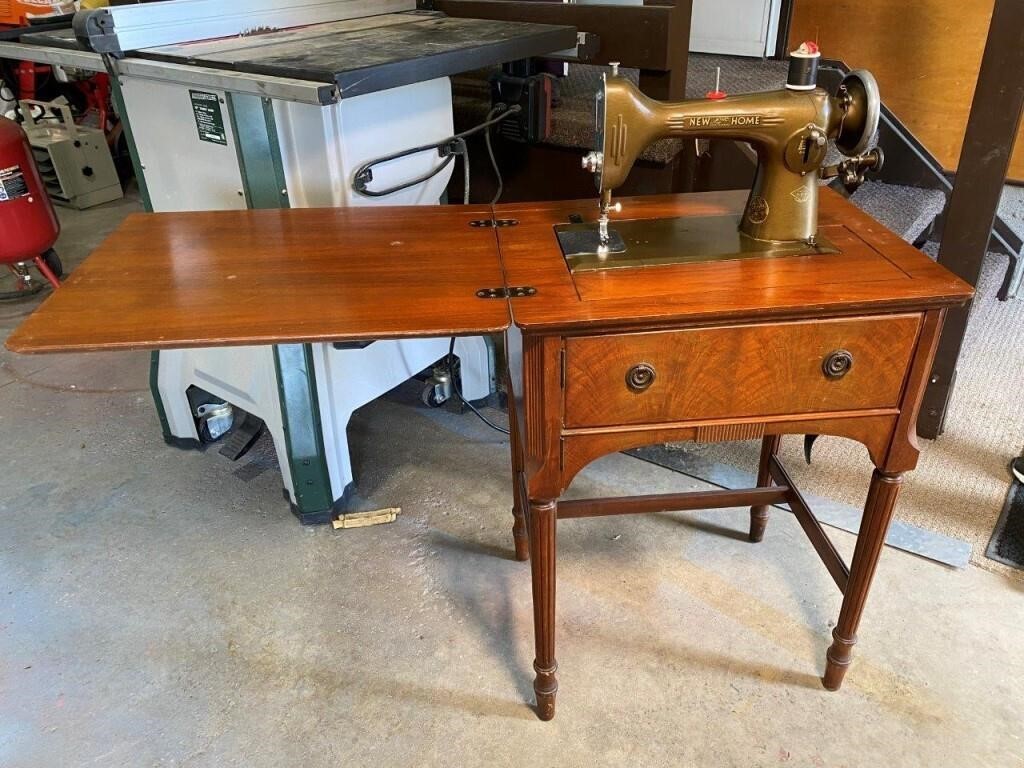 vintage NEW HOME sewing machine in cabinet