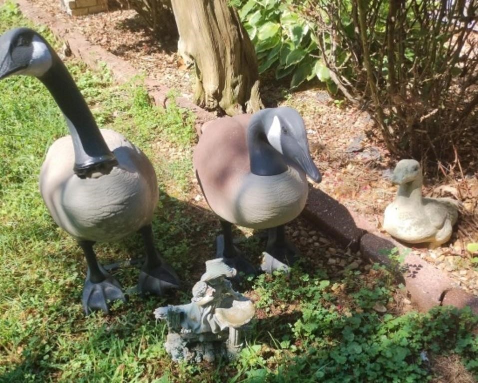 Yard decor including geese, child statue and a