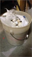 One 5 gallon bucket filled with used golf balls,