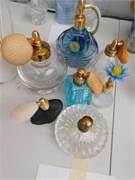 Seven vintage glass perfume bottles, most with