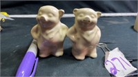 Pig salt and pepper shakers , one has chip on ear