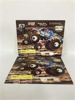 Two autographed monster truck photos