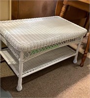 White plastic wicker coffee table with a shelf