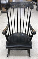 Black wooden rocking chair with gold artwork