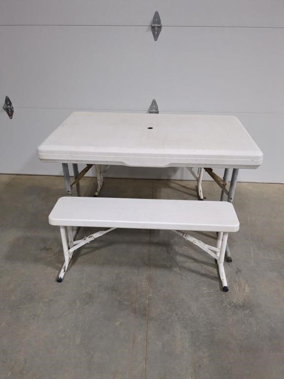 White plastic resin folding picnic table with 2