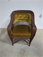 Wicker chair with green cushion and back (