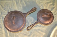Cast iron lot:  2qt. and 3qt. sauce pans with lids