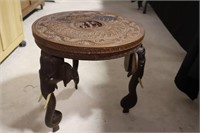 Ornate carved side table with elephant