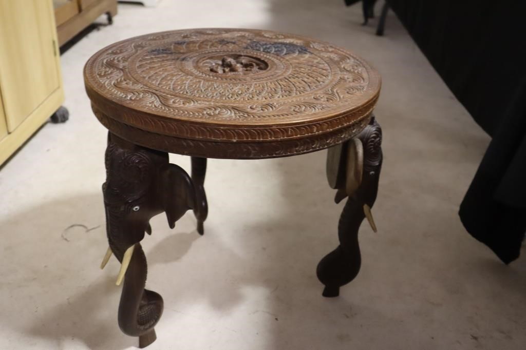 Ornate carved side table with elephant