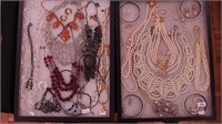 Two containers of costume jewelry: 1928,