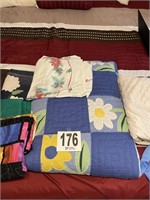 Linens, quilts, and throw blankets in tote