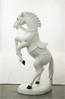 A wood carved white rearing horse statue
