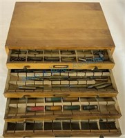 Antique spool cabinet containing bullet collection