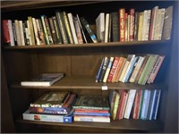 Three shelves of books and puzzles