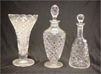 Two cut crystal spirit decanters and a vase