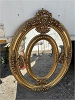 ORNATE OVAL SECTIONED GOLD MIRROR