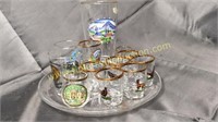 Collection of shot glasses on glass plate