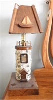 Figural lighthouse table lamp with wooden shade