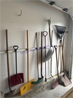 GARDEN TOOLS ON GARAGE WALL--RAKES, SHOVELS,