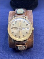 Leather cuff watch with date