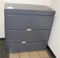 Grey metal three drawer locking file cabinet