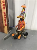Wind up toy duck on bike