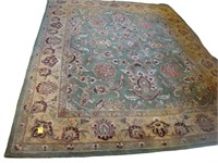 Floral wool rug in green and earthtone colors 8’