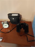 Vintage alarm clock and set of binoculars 16x50