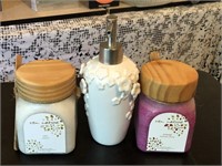 Two candles with soap dispenser