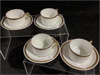 Four matching tea cups with saucers