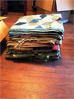 Stack of crazy quilts and quilts some damage