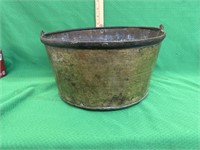 Antique brass apple butter pan with a hand