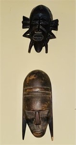 Two carved wood African masks, the top one