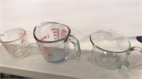 2 measuring cups and 1 glass pitcher