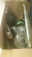 Box with a variety of pots and pans and lids