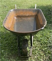 Wheel barrow and roll of chain link fence