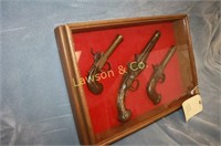 3 OLD PISTOLS IN A SHADOW BOX
