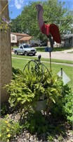 Metal outdoor planter and cardinal yard art.