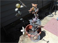 Flower Pot Full of Metal Yard Art Pieces