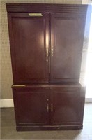 Two-piece wooden fold-away entertainment armoire.