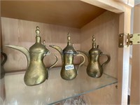 3- brass pitchers. Flip lids, unique