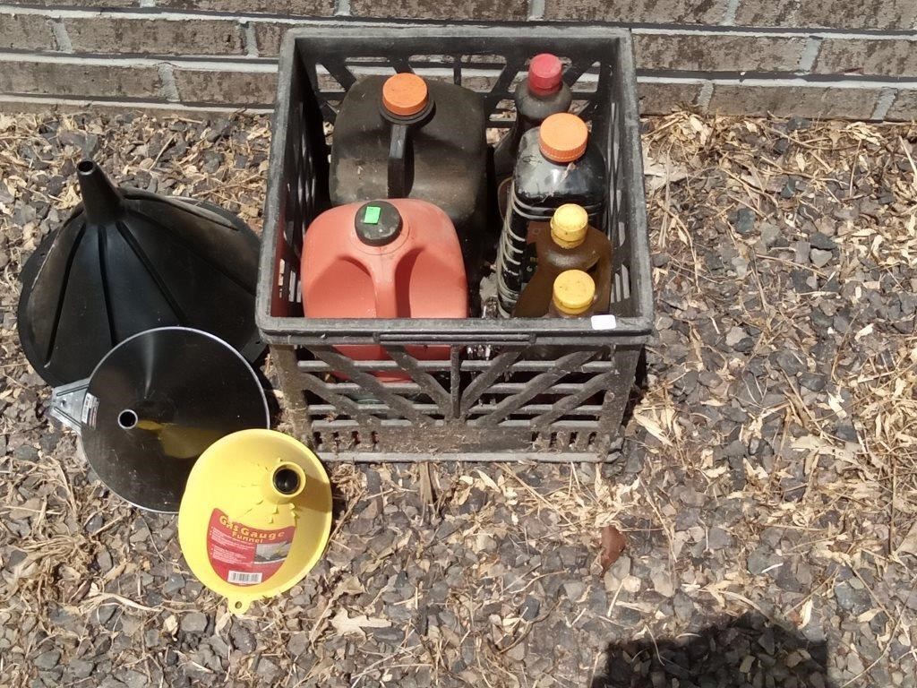 crate with funnels,bug spray & oil