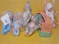 6 like new dolls 
approx. 8" tall