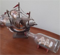 Ship in a bottle and a small ship.