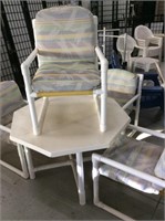 PVC patio table with four cushioned chairs